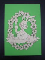 Rabbit with carrot in a wreath of flowers